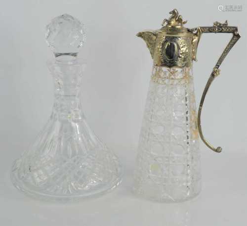 A cut glass claret jug with silver plated mounts, the top an...