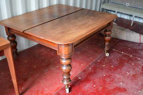 A large Victorian mahogany dining table with three extra lea...