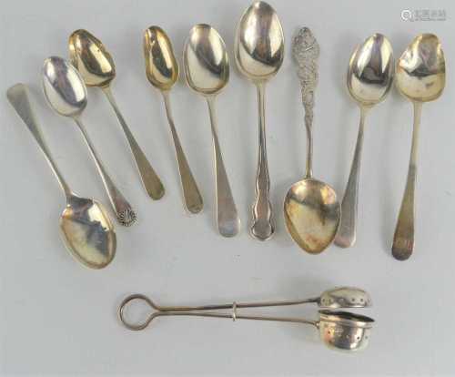 A silver tea strainer and nine silver teaspoons, Sheffield a...