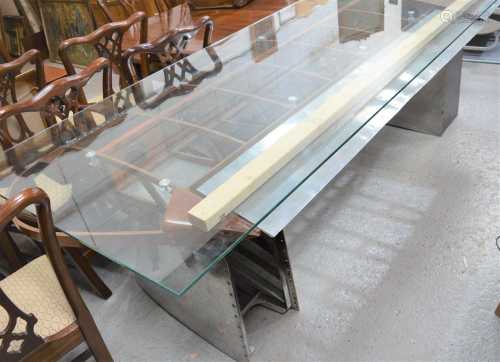 A hand made aeroplane wing dining table with glass top on sh...