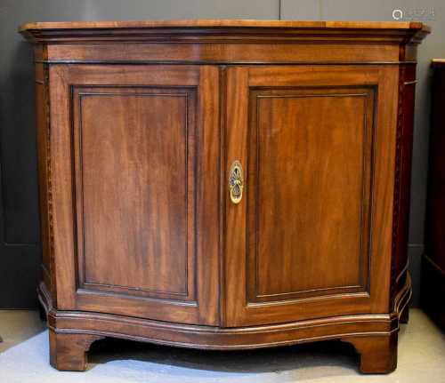A late 19th century serpentine cabinet, with two panelled do...