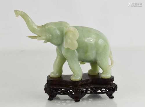 A Chinese jade carving of an elephant raised on a stand, 14c...