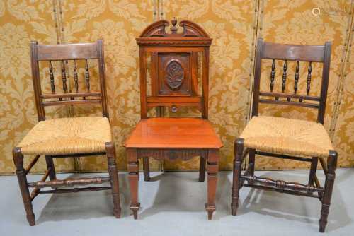 A Victorian hall chair, the back carved with a six petalled ...