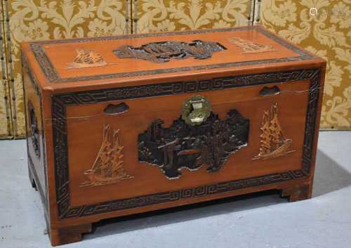 A large Chinese camphor wood chest, the carved frieze depict...