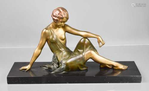 An Art Deco spelter figure of a woman beside doves, raised o...