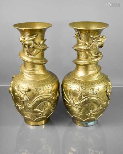 A pair of 19th century Chinese brass vases, modelled with dr...
