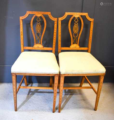 A pair of satinwood saloon chairs in the Sheraton revival st...