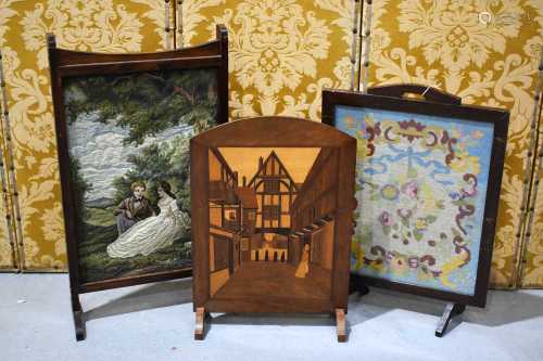 A pair of vintage firescreens, one a needlework tapestry exa...