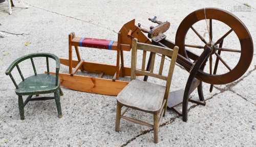 A vintage wooden rocking horse together with a spinning whee...