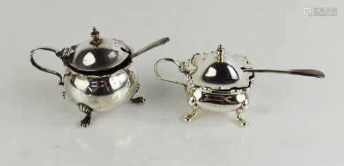 Two silver mustard pots and covers, both with blue glass lin...