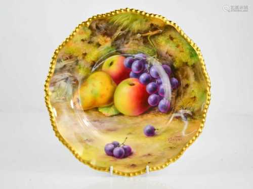 A Royal Worcester plate painted with fruit on a mossy ground...