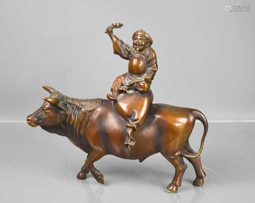 A Japanese bronze man riding a water buffalo, 30cm high.