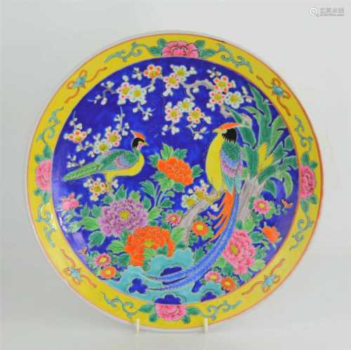 A 20th century Chinese enamelled plate decorated with exotic...