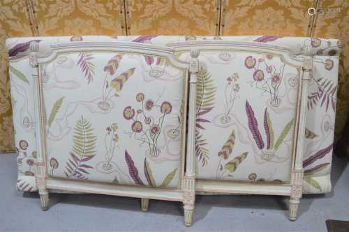 A French style day bed, painted cream and upholstered in a f...
