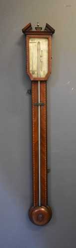 A George III mahogany stick barometer, the case inlaid with ...