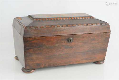 An antique rosewood tea caddy raised on bun feet16.5cm high ...