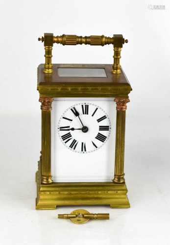 A French brass carriage clock, with Roman numeral dial flank...