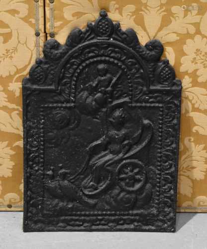 An early cast iron fireback, cast with peacocks and woman in...