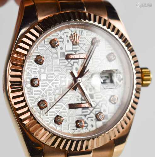 A Rolex style rose gold coloured wristwatch.