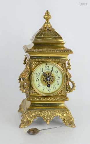 An early 20th century brass mantle clock with enamelled dial...