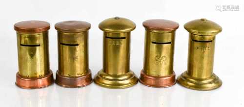 A group of brass novelty money boxes in the form of a post b...