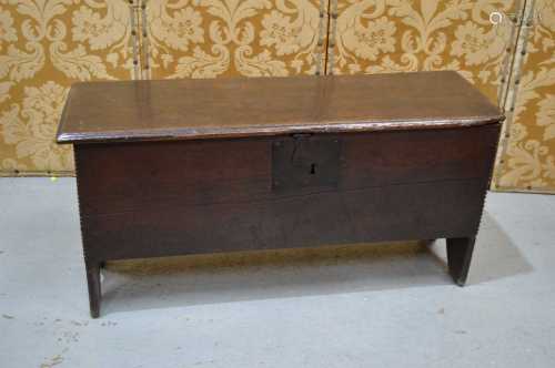 A 17th century oak boarded coffer with single plank lid, can...