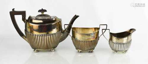 A silver tea set comprising tea pot, sugar bowl and milk jug...