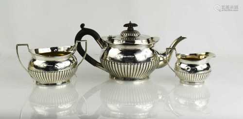 A silver tea set, comprising tea pot, sugar bowl and milk ju...