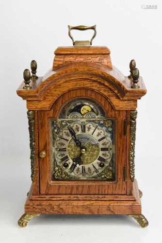 A Warmink Wuba oak and brass mantle clock with acorn finials...