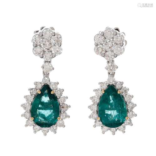 Emeralds and diamond dangling earrings.