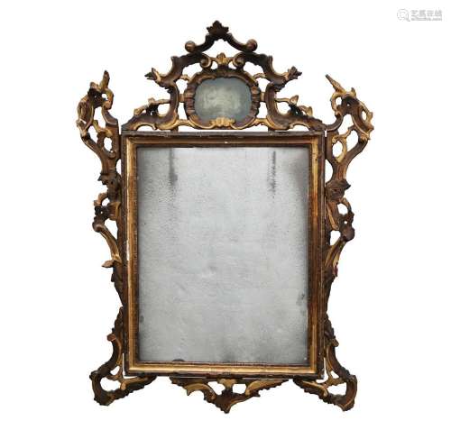 Venetian ornamental mirror with carved and gilded wood frame...