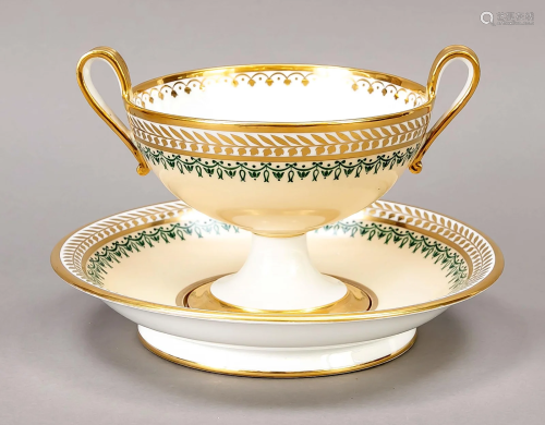 A bowl with handles and a sauc
