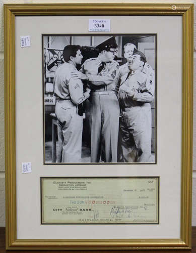 AUTOGRAPHS. A cheque signed by Phil Silvers, mounted below a...