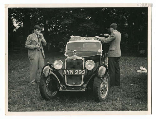 SINGER. A black and white photograph of two men eating a pic...