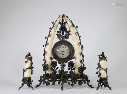 Colonial clock, in wrought iron and carved tusks circa