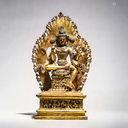 A GILT BRONZE FIGURE OF BUDDHA WITH AUREOLE