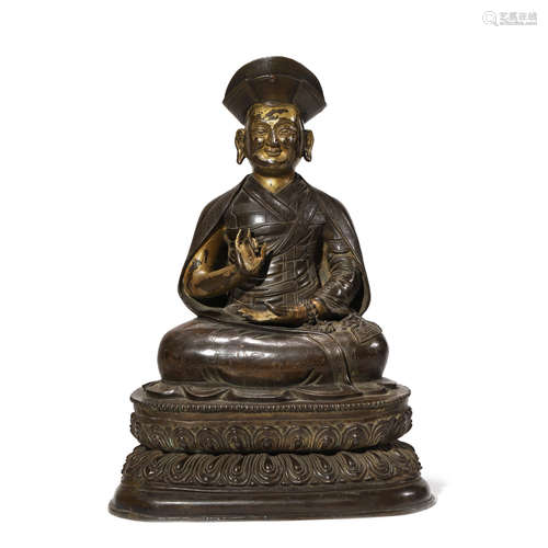 A GILT COPPER FIGURE OF GURU