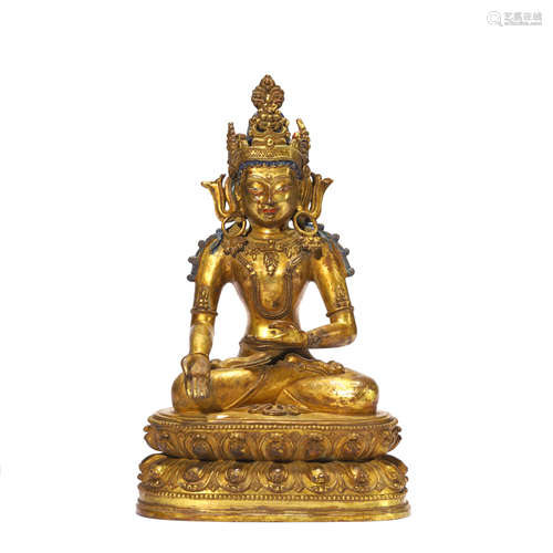 A GILT BRONZE FIGURE OF CROWNED SHAKYAMUNI