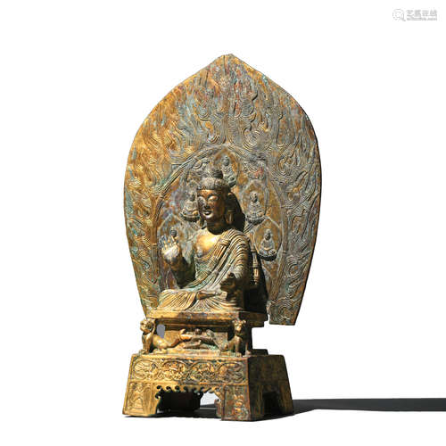 A GILT BRONZE FIGURE OF BUDDHA WITH AUREOLE