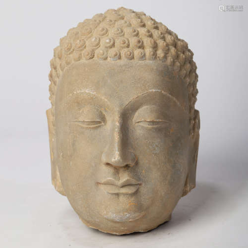 A CHINESE CARVED STONE HEAD OF BUDDHA