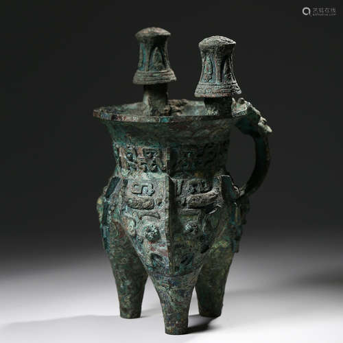 A BRONZE TRIPOD LIQUOR VESSEL