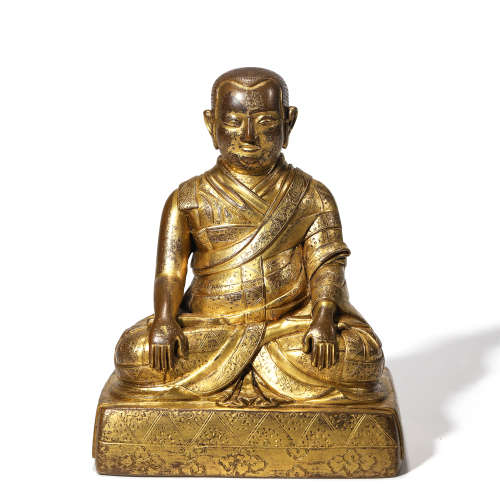 A GILT BRONZE FIGURE GURU