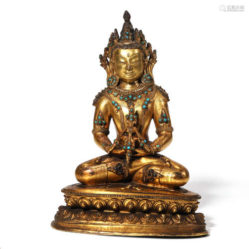 AN INLAID GILT BRONZE SEATED BUDDHA