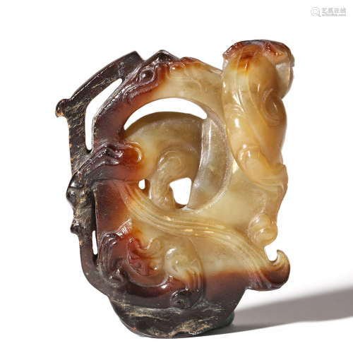 A CARVED BROWNISH JADE ORNAMENT