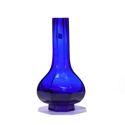 A BLUE GLASS HEXAGONAL BOTTLE VASE
