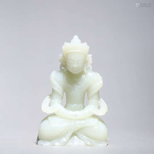 A CARVED JADE FIGURE OF CROWNED BUDDHA