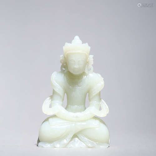 A CARVED JADE FIGURE OF CROWNED BUDDHA