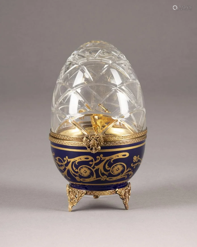 A EGG-SHAPED SILVER-GILT, CUT-GLASS AND PORCELAIN BOX