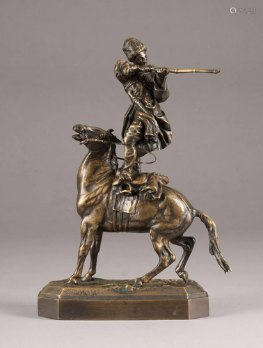 A BRONZE FIGURE OF A COSSACK