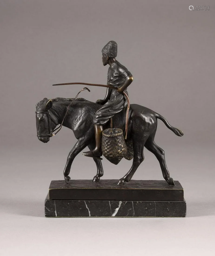 A BRONZE FIGURE OF A DONKEY RIDER